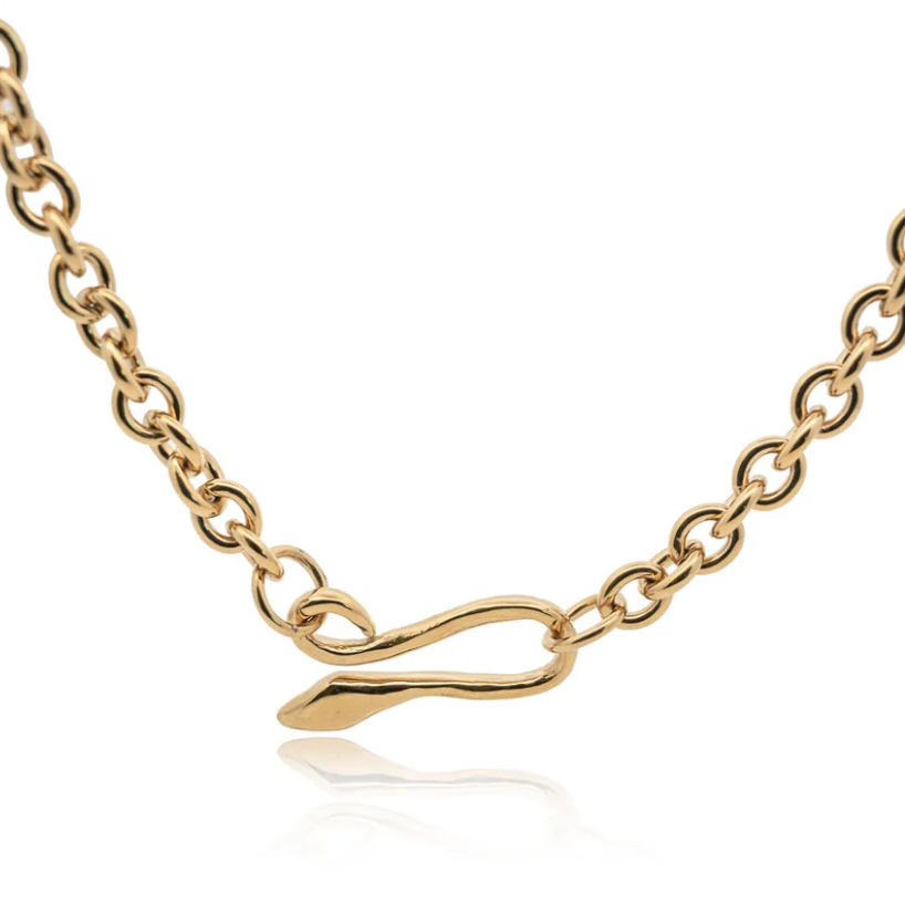 Crafted with a unique hand-sculpted snake clasp that acts as the focal point and a thick brass cable chain