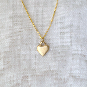 Solid gold pendant on delicate gold chain