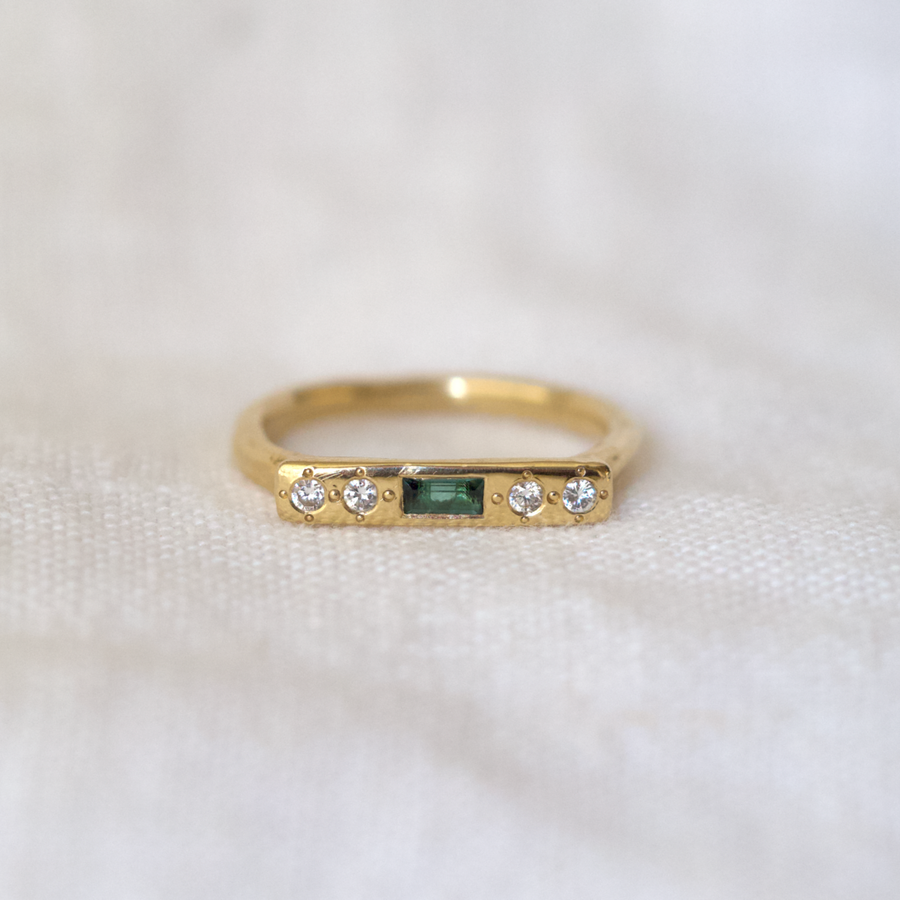 Our 14k gold Message style ring, set with a vibrant green tourmaline baguette and 4 side brilliant cut diamonds.