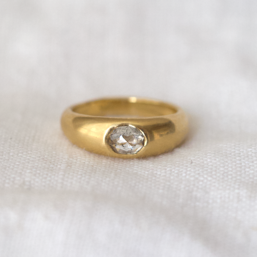 Tick domed solid gold ring with oval salt and pepper rose cut diamond in the center