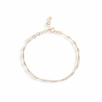 14k gold bracelet of long bar links, with four alternating bars in the center set with  4 white diamonds in them.