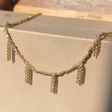 14k gold chain bracelet with small chain fringe that hangs down and adds some movement