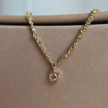 14k gold woven chain necklace with small pendant at the center, set with a warm brown Champagne diamond. 