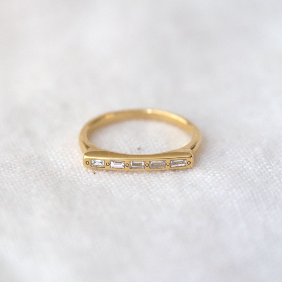 A slimmer version of our Message ring, this thin 14k signet band has a skinny flat face, perfect for the five Baguette cut white diamonds to be set in a row.