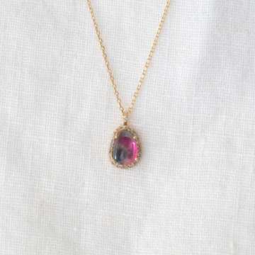 Beautiful pear shaped Watermelon Tourmaline, prong set in 14k gold and surrounded by a halo of small white Diamonds