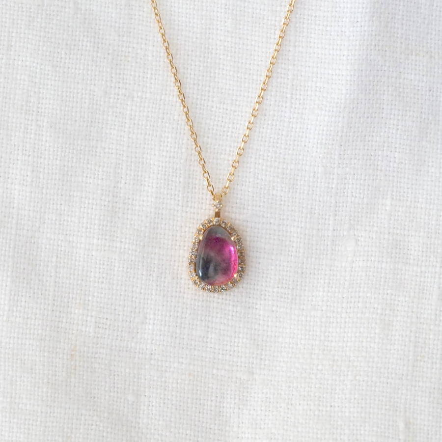 Beautiful pear shaped Watermelon Tourmaline, prong set in 14k gold and surrounded by a halo of small white Diamonds