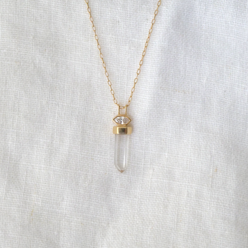 one clear quartz set in a band of 14k gold, hanging below a marquise diamond bezel set in 14k gold. Comes on 14k gold small paperclip chain