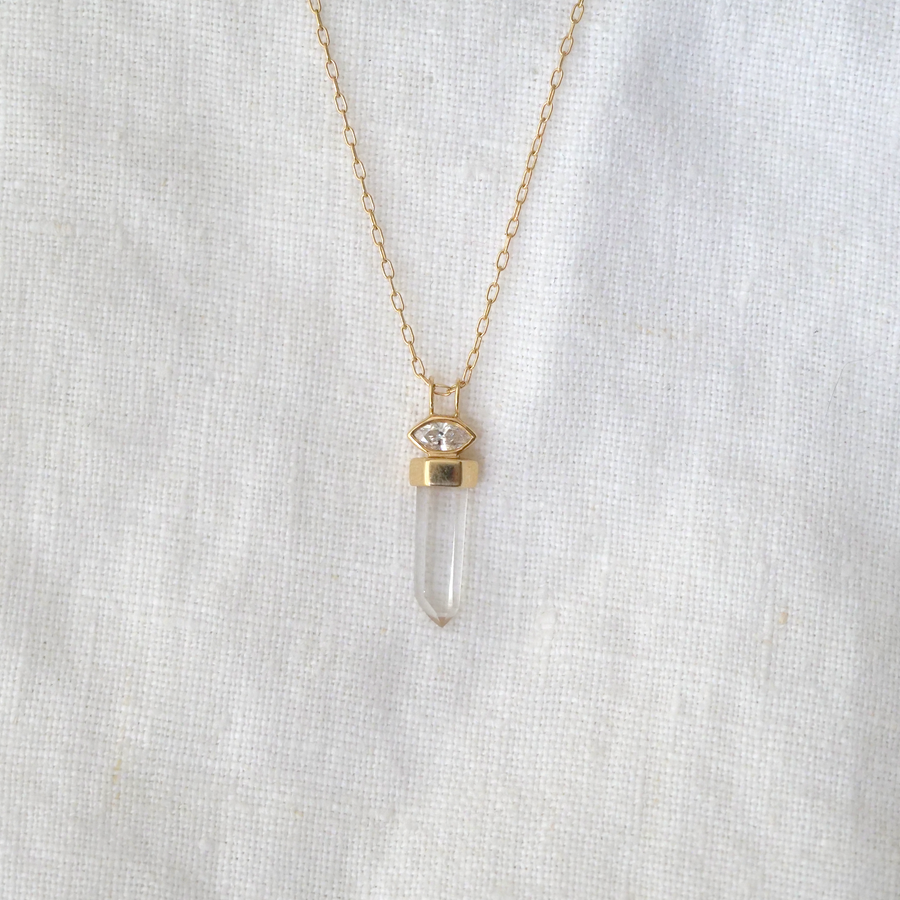 one clear quartz set in a band of 14k gold, hanging below a marquise diamond bezel set in 14k gold. Comes on 14k gold small paperclip chain