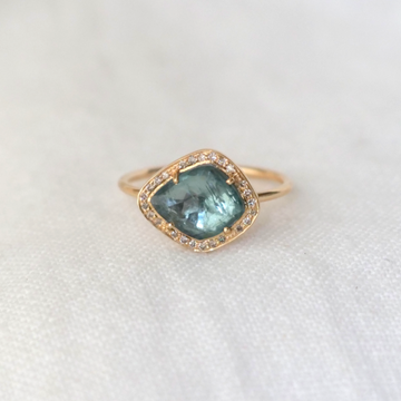  soft blue irregular tourmaline, surrounded by white diamonds, set in 14k yellow gold. 