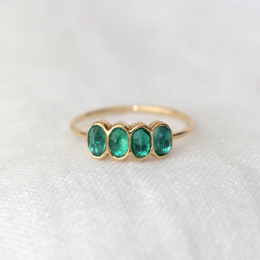 Four oval emeralds bezel set in 14k gold on a thin gold band