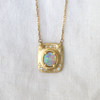 Australian crystal opal has a beautiful play of color and changes with the change of light reflecting from it. The 18K gold setting hosts a lovely dusting of pave white diamonds.  