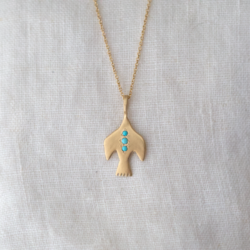 Solid 14k gold bird pendant with three turquoise cabochon points down the center on a 14k chain 