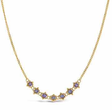 Seven Tanzanites in a perfect periwinkle shade adorn the center of this necklace.