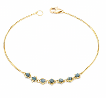 Two swaths of 18k yellow gold chain lead to this bracelet’s striking centerpiece: a row of seven extraordinary Blue Diamonds, each glittering bead precisely hand-woven into a web of delicate yellow gold chain