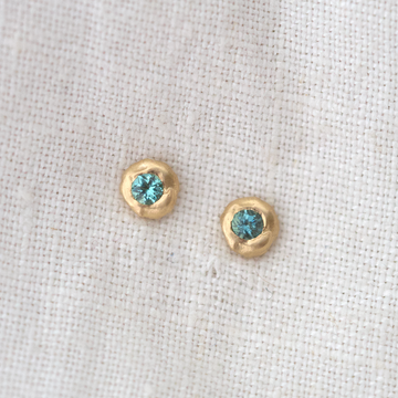 These little studs are organically shaped of gold with tourmaline flush set in the center