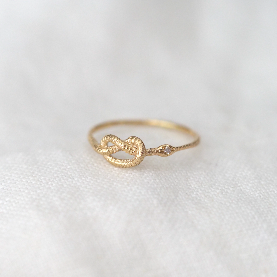 A lucky charm snake ring with a stone set in the little head. The snake motif, which represents permanence, has been considered a talisman since ancient times. 