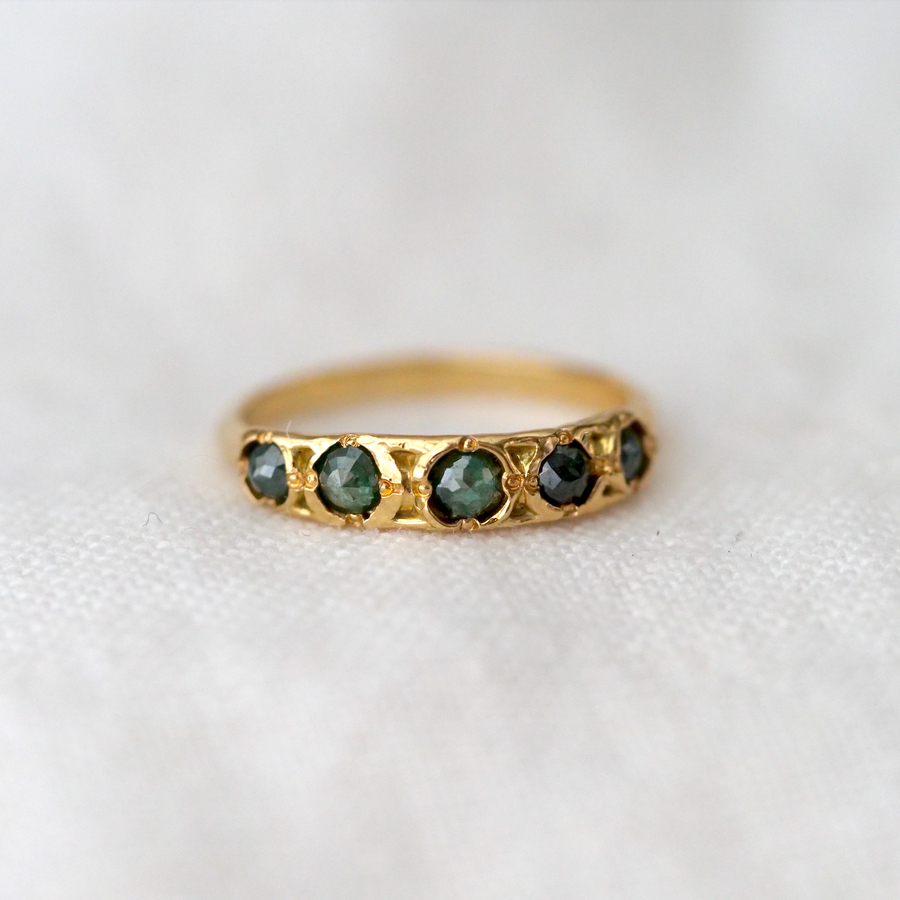 Five dazzling rough cut green diamonds, inlayed in beautiful gold with small detailing in between.