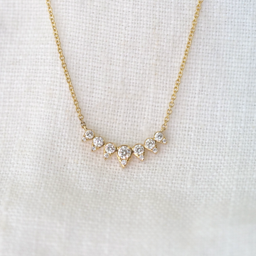 This dainty statement maker features a curving sunburst style with bright white diamonds