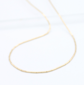 thin gold beads on a strand 