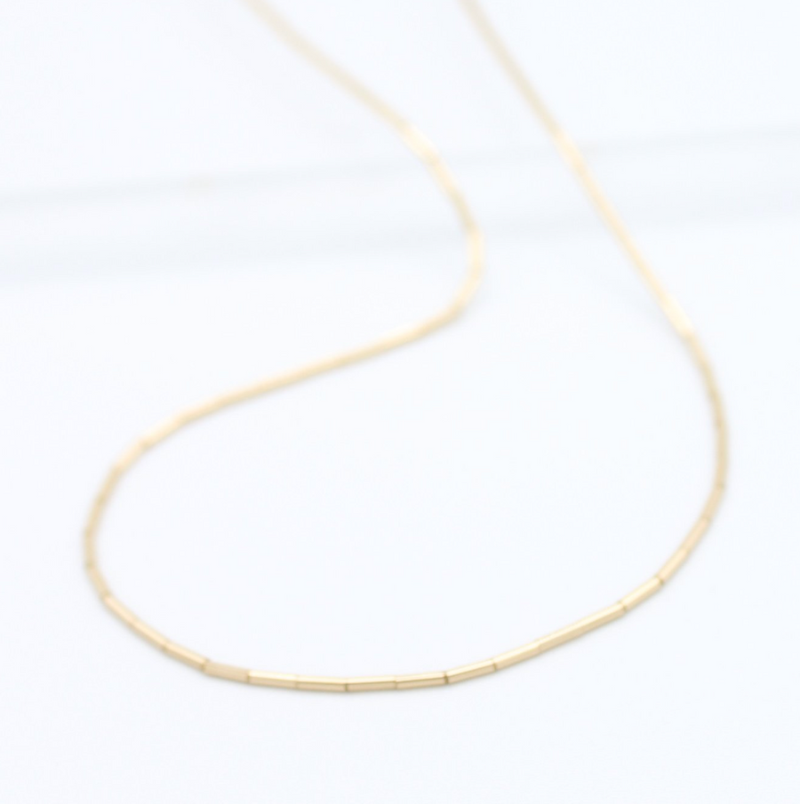 thin gold beads on a strand 