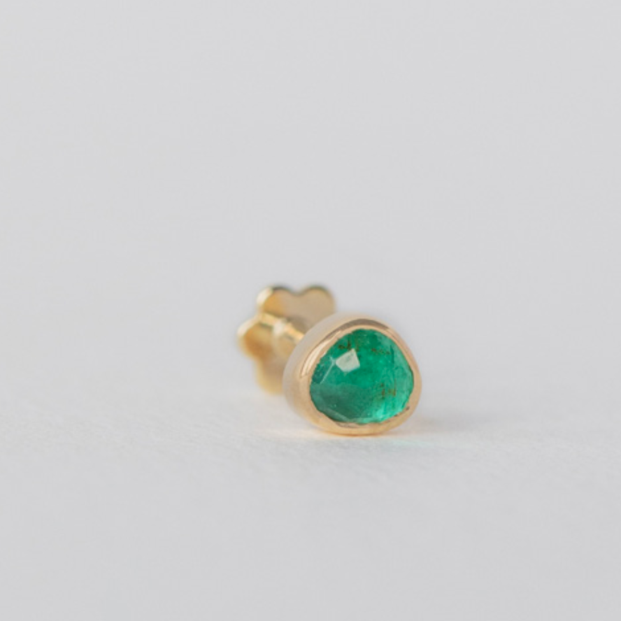 organically shaped green emerald bezel set in 14k gold with the flat back post