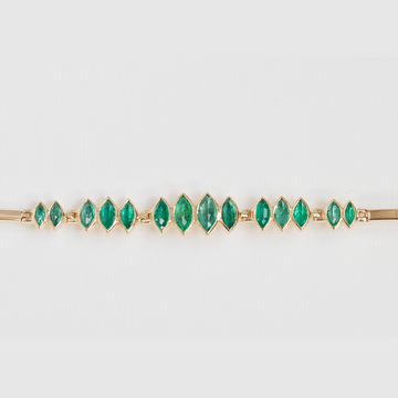 One of a kind solid yellow 14k gold bracelet with irregular oval emeralds, that are in articulated groups of two, three and four