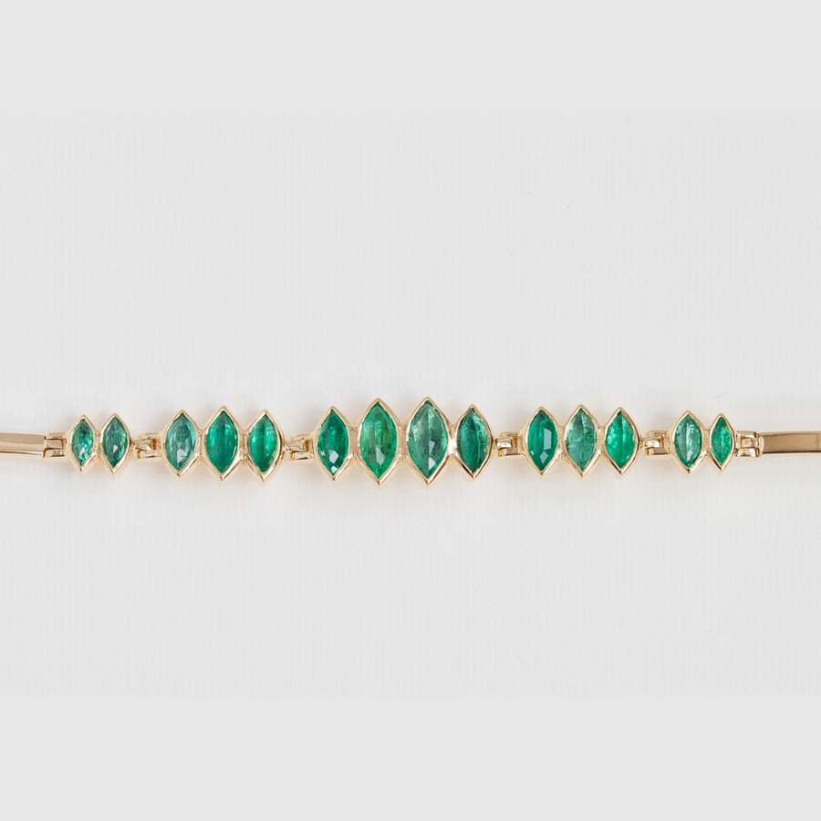 One of a kind solid yellow 14k gold bracelet with irregular oval emeralds, that are in articulated groups of two, three and four