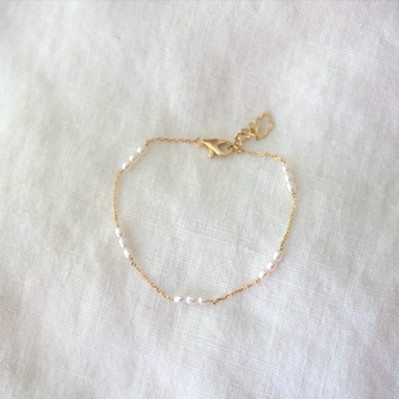 14k shimmery chain with five groups of three pearls evenly strung along it