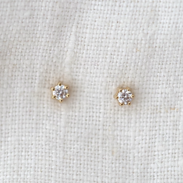 These classic 14k gold studs with 3 white diamonds prong set in a row