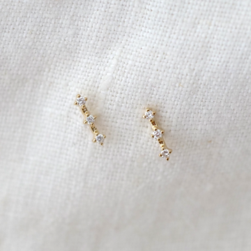 These classic 14k gold studs with 3 white diamonds prong set in a row.