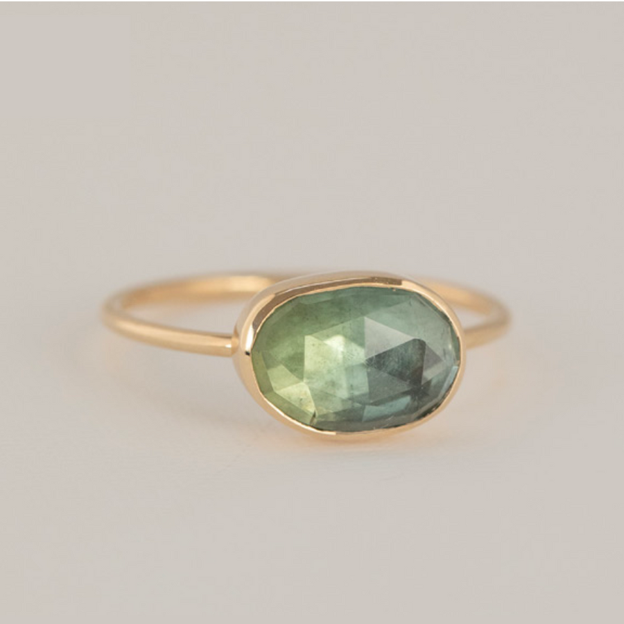 Celine Daoust 14k light yellow gold ring with one irregularly shaped light green tourmaline, bezel set.