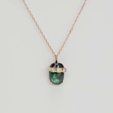 oval green tourmaline crowned with 3 square white diamonds set in 14k gold