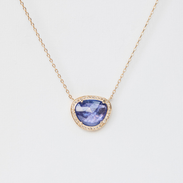 magnificent purple tanzanite surrounded by dazzling diamonds on delicate gold chain