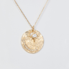 14K light yellow gold sun and moon medallion pendant with diamonds set in the moon and a sapphire star.