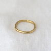 3 of 6: handcrafted 2.5mm solid gold band, showcasing a natural texture and wavy profile