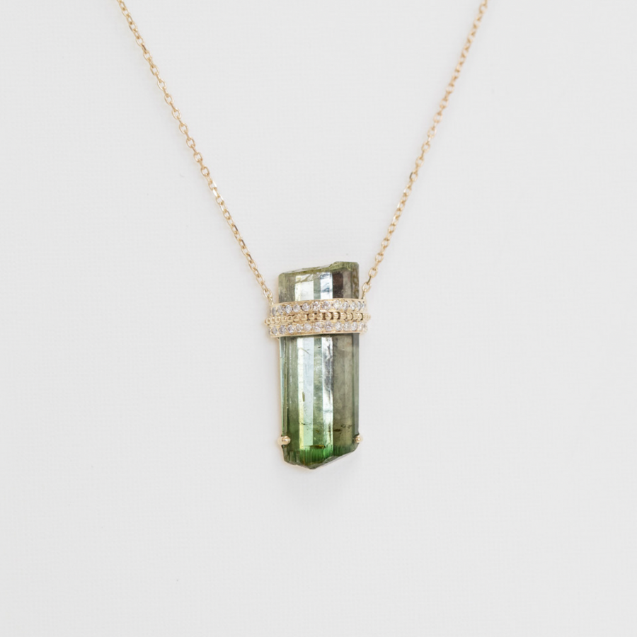 Necklace with a green crystal pendant on a white background