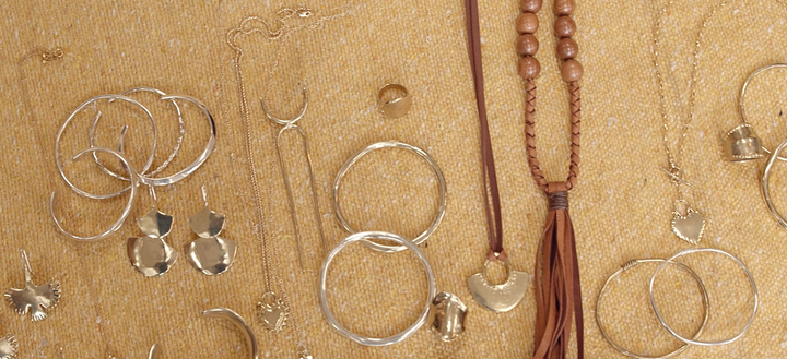 Jewelry laid out on yellow blanket 