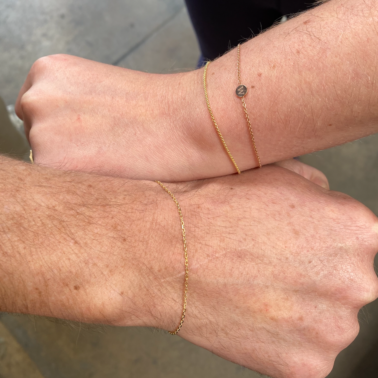 man and woman with gold chain bracelets 