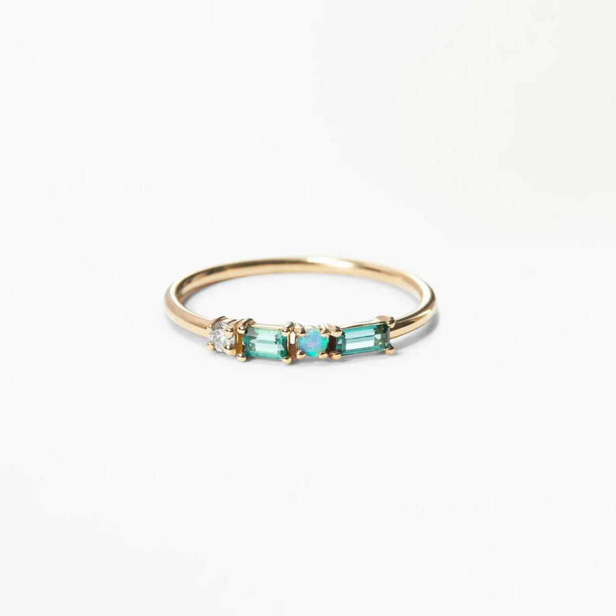 a brilliant white diamond, a small round opal, and a gradation of green tourmalines prong set on a thin gold band