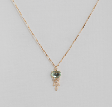 light green stone and diamonds in 14k yellow gold over white backdrop
