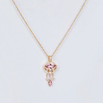 pink marquise necklace in gold on white backdrop