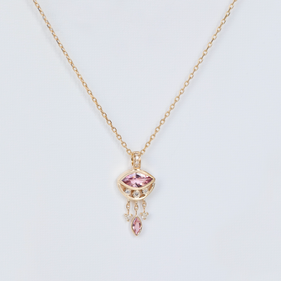 pink marquise necklace in gold on white backdrop