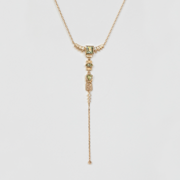 detailed diamond and green tourmaline gold necklace lariat on white backdrop