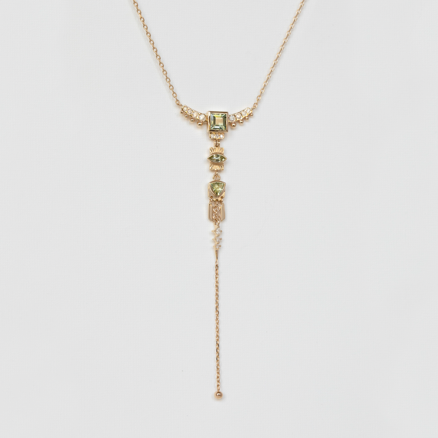 detailed diamond and green tourmaline gold necklace lariat on white backdrop