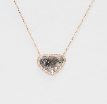 grey diamond slice surrounded by white diamonds on gold chain on white background 
