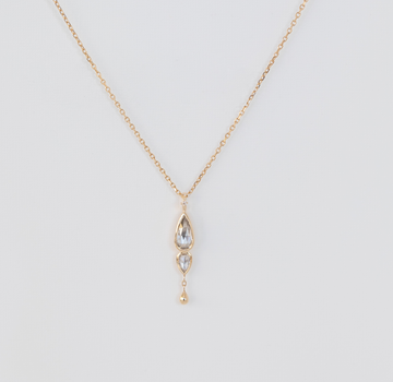 diamond pendant dangling from 14K chain on white background
