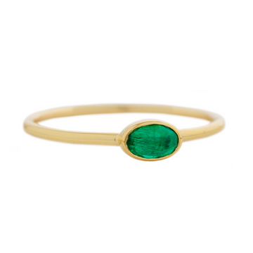 A sweetly sized but bright emerald is set simply on a 14k band.