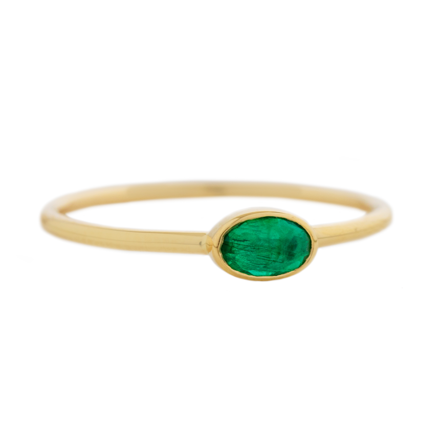 A sweetly sized but bright emerald is set simply on a 14k band.