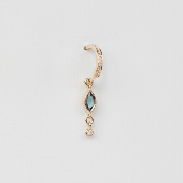 Crafted with 14K light yellow gold, this single hoop earring features a stunning Blue Marquise Tourmaline and a dangling diamond.