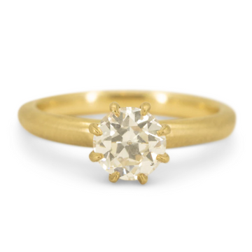 A classic 8-prong solitaire ring showcasing an Antique Round White Diamond set in 18k yellow gold